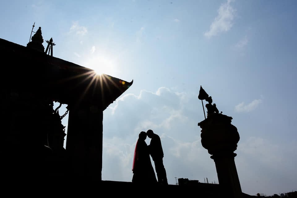 Silhouette of a couple by a Bhaktapur temple at sunrise