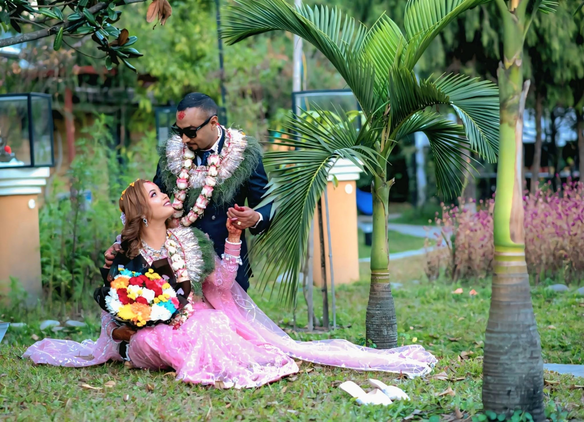 Newly married couple photographed in a garden