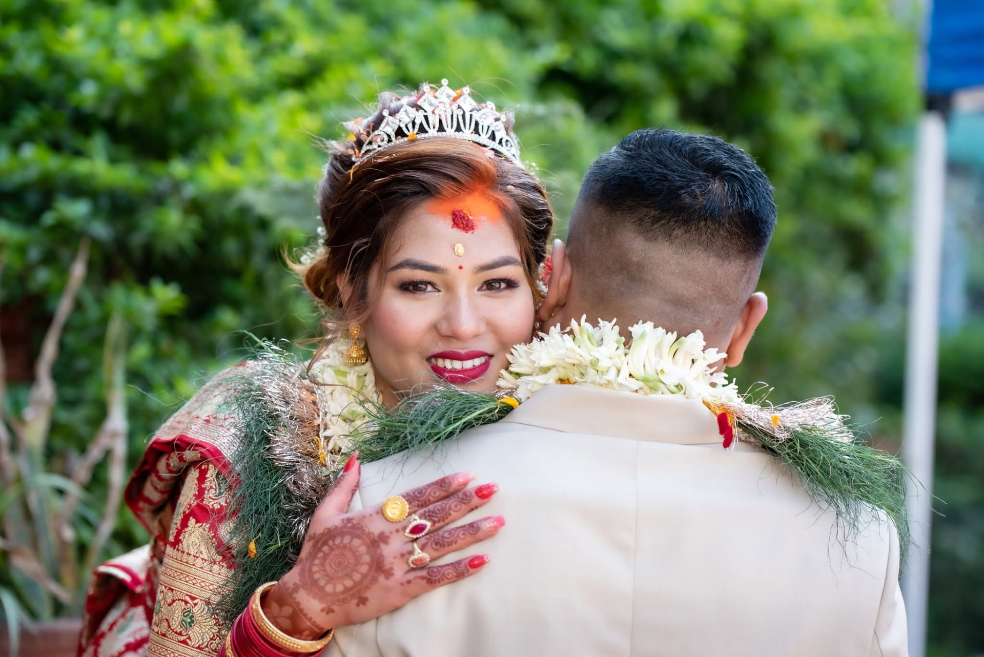 Bride smiling while embracing the groom on the wedding day