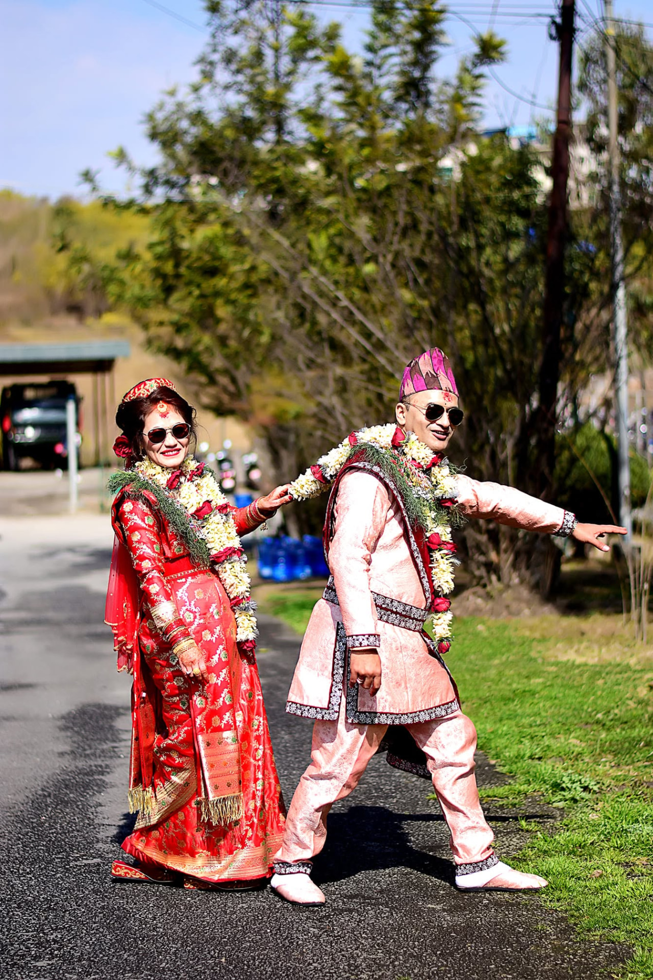 Couple in traditional Nepali wedding attire walking outdoors